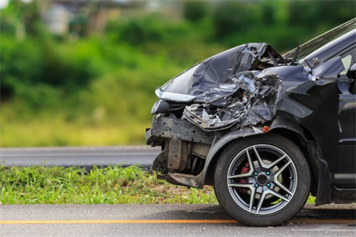 A car with severe front-end damage after a collision, representing the real-world scenario of an autonomous driving accident.