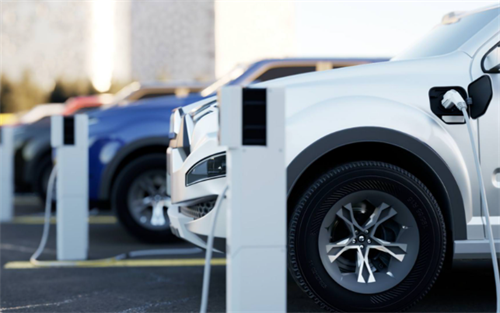 Electric vehicles charging at a public station, representing current EV ownership in the transition to solid-state batteries.