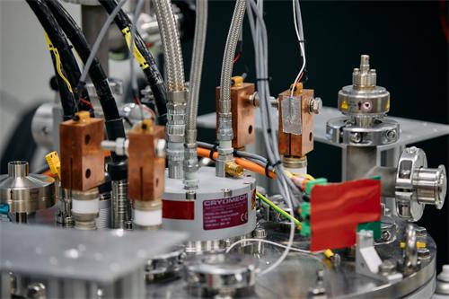 Close-up shot of Cryomech cryogenic industrial vacuum machinery with copper heat blocks and wiring